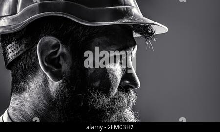 Worker in hardhat. Portrait mechanical worker. Bearded man in suit with construction helmet. Portrait of handsome engineer. Builder in hard hat Stock Photo