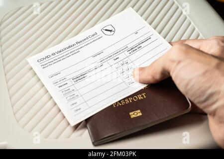Covid-19 vaccination record card and passport Stock Photo