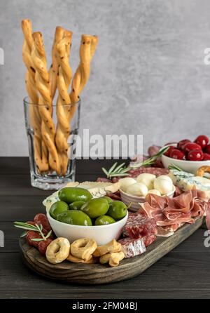 Appetizers board with different italian antipasti, cheese, charcuterie, and crackers Stock Photo