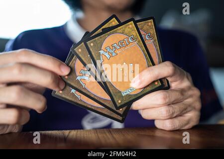 Bangkok, Thailand - May 2, 2021 : A man playing Magic The Gathering card game. Stock Photo