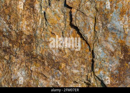 Natural stone surface. Colorful formation of rock layers. Multicolored stone texture background. Stock Photo