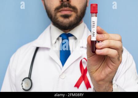 Sti Ribbons Red ribbon with stethoscope, blood sample and heart on grunge white ...