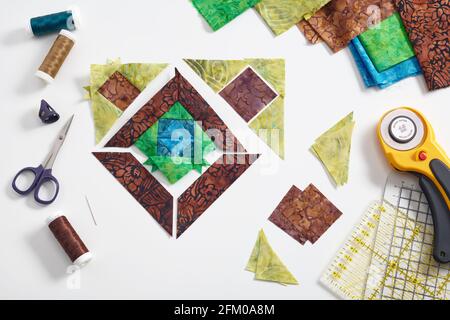 Pieces of fabric laid out in the shape of a patchwork block, sewing and quilting  accessories. Traditional quilting Stock Photo - Alamy