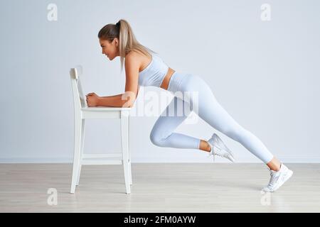 Adult beautiful woman working out over light background Stock Photo