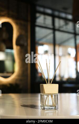 Reed Diffuser With Wooden Sticks In Turquoise Glass Bottle Candles Bouquet  Of Flowers On Table Gray Wall Background Aromatherapy Home Interior Decor  Wellbeing Concept Cozy Atmosphere Stock Photo - Download Image Now 