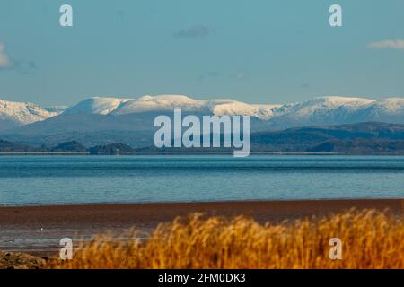 Morecambe Bay, Lancashire, UK. 5th May, 2021. Snow on the fells behind Arnside Knott Credit: PN News/Alamy Live News Stock Photo