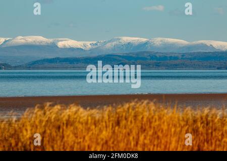 Morecambe Bay, Lancashire, UK. 5th May, 2021. Snow on the fells behind Arnside Knott Credit: PN News/Alamy Live News Stock Photo