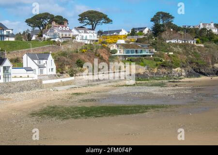 Abersoch Beach in April,out of season,empty beach,beaches,and,closed,beach huts,Abersoch,Llyn Peninsula,Gwynedd,North Wales,Wales,Welsh,Europe.  In Abersoch, a coastal village on the Llŷn Peninsula, about 39% of homes are second homes.Welsh village dubbed 'Cheshire-by-the-Sea' because number of holiday homes snapped up by wealthy owners.families have been priced out by people snapping up coastal properties for second homes Stock Photo