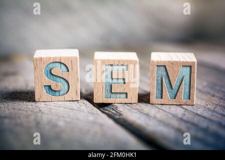 SEM Search Engine Marketing Written On Wooden Blocks On A Board Stock Photo