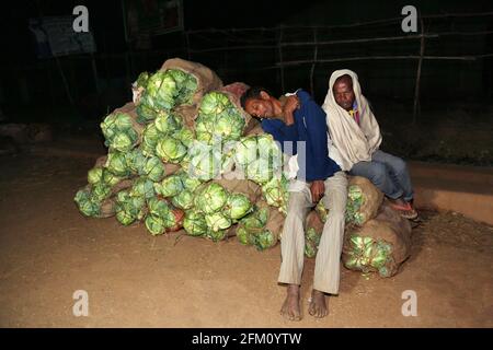 Konda Doras and Nooka Doras tribal men taking rest at night market in Araku Village, Andhra Pradesh, India Stock Photo