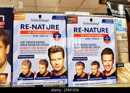 Berlin, Germany - April 22, 2021: View to a shelf with packs of hair dye in a supermarket. Stock Photo
