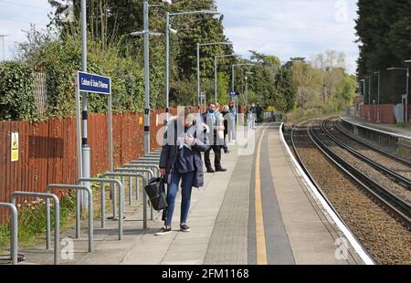 Passengers wait on the platform at Cobham and Stoke D'Abernon Station, Surrey, UK Stock Photo