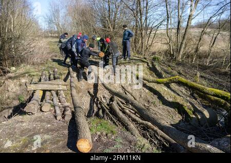 Kaliningrad region, Russia, March 15, 2020. Building a bridge for pedestrians. Bridge over the ditch. Log Bridge. Stock Photo