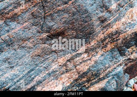 Background fill. Natural stone background. Sea stone texture. Panel texture. Spots gray red background. Stock Photo