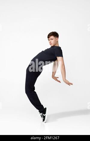 Handsome young man in black t-shirt jumping. Stock Photo