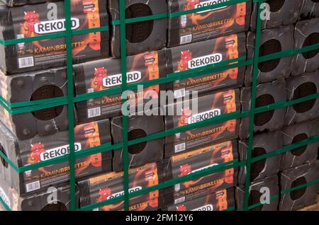 Bamberg, Germany - 10.4.2021. Brand Rekord-brand edcoal briquettes are stored on a pallet in front of a hardware store Stock Photo