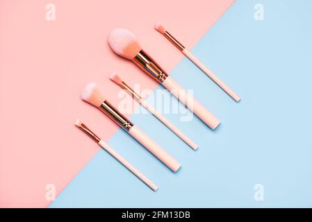 Different make up brushes.Make Up Beauty Fashion Concept on a pink and blue background.Make Up Beauty Fashion Concept Stock Photo