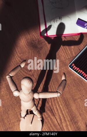 Image of a backlit drawing mannequin with colored pencils and a sketchbook Stock Photo