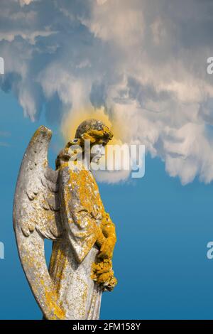 An angel statue against a surreal cloud formation sky Stock Photo