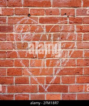 Background of a chalk drawn heart on a brick wall Stock Photo