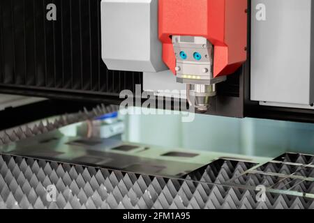 Automatic cnc laser cutting machine working with sheet metal at factory Stock Photo