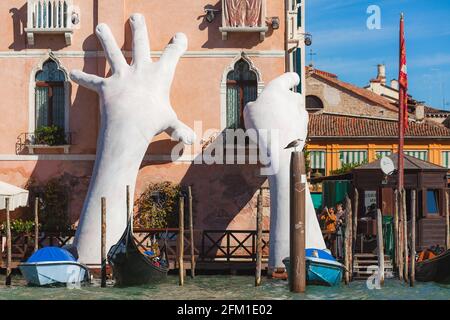 VENICE, ITALY - 07 October, 2017 Gigantic sculpture called Support for the Biennale 2017. Author - Lorenzo Quinn. The composition is dedicated to global warming Stock Photo