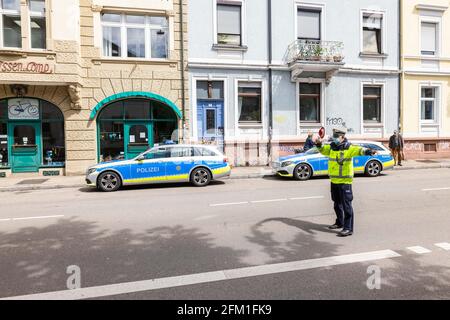 Freiburg, Germany. 05th May, 2021. A police officer waves a vehicle (not in the picture) to the side of the road for inspection. This year, the cross-state campaign 'sicher.mobil.leben' (safe.mobile.living) focuses on safety in cycling. Credit: Philipp von Ditfurth/dpa/Alamy Live News Stock Photo