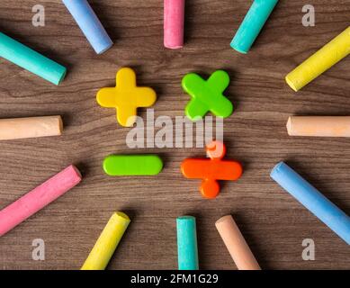 Mathematical math symbols with color chalks on wooden background Stock Photo