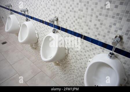 Modern prívate school bathroom, with new tiles, sink, toilette paper. Stock Photo