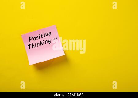 Motivational positive thinking word on note pads on yellow background Stock Photo