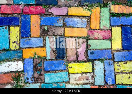 Top view on pieces of multicolored ceramic tiles decorated in garden. Old pavement of tiles textured. Street mosaic cobblestone sidewalk. Abstract,bac Stock Photo