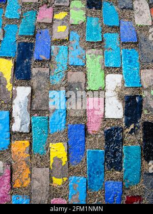Top view on pieces of multicolored ceramic tiles decorated in garden. Old pavement of tiles textured. Street mosaic cobblestone sidewalk. Abstract,bac Stock Photo
