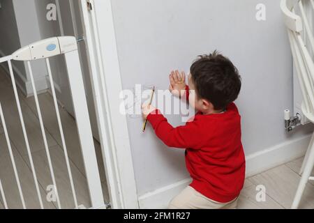 A Young Boy Pictured Drawing On The Walls With A Pencil In West Sussex Uk Stock Photo Alamy