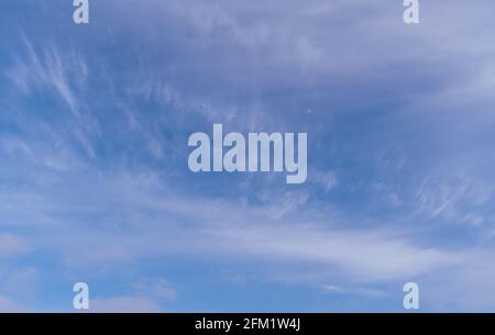 Abstract template with blue sky, white clouds and waxing half moon. Beauty of nature concept. Abstract natural background. Stock Photo