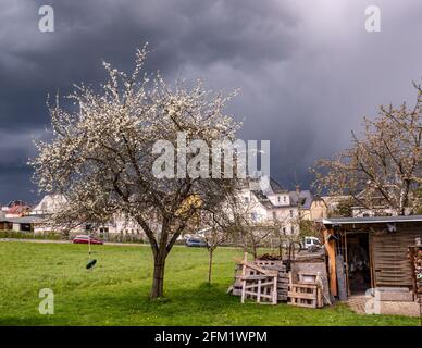 Storm clouds in the sky over a village Stock Photo