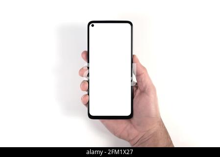 hand holding smartphone with blank white screen against white background, person using smartphone template with copy space Stock Photo