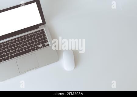 Top view computer laptop mock up and mouse white blank screen on table. Copy space vintage tone. Stock Photo