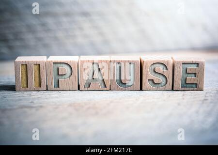 Pause Written On Wooden Blocks On A Board Stock Photo