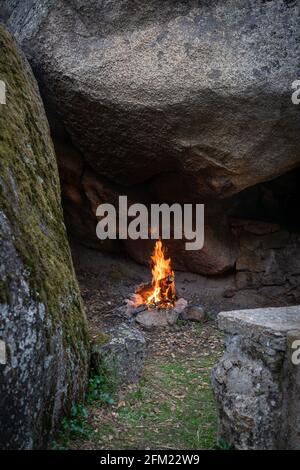 Fire pit bonfire on the middle of boulders stones full with moss in wild nature Stock Photo