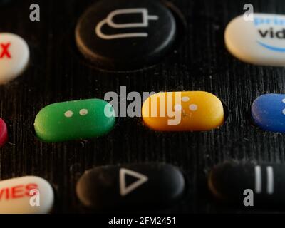 Selective focus shot of black remote control colorful rubber buttons Stock Photo