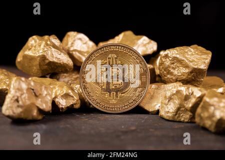 Bitcoin cryptocurrency with gold nuggets. Investment and store of value concept. Stock Photo