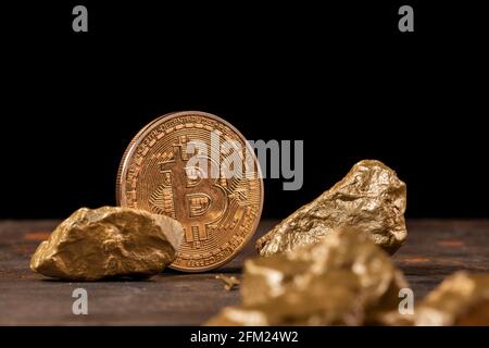 Bitcoin cryptocurrency with gold nuggets. Investment and store of value concept. Stock Photo