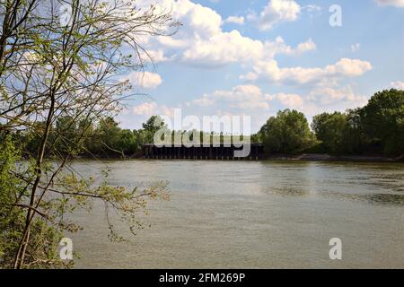 River on a clear day with power lines crossing it Stock Photo