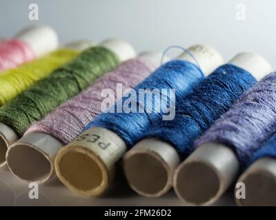 Sewing threads multicolored background closeup, selective focus, macro Stock Photo