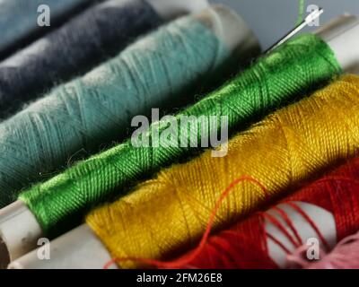 Sewing threads multicolored background closeup, selective focus, macro Stock Photo