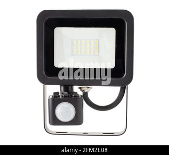 Motion sensor LED floodlight in hand on white background isolation. Stock Photo