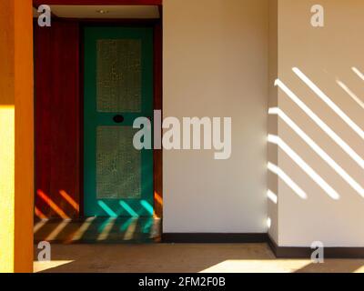 A delicate play of light on a green painted door in the morning. At the famous architect Geoffrey Bawa's Jetwing Lighthouse Hotel Resort near Galle, S Stock Photo