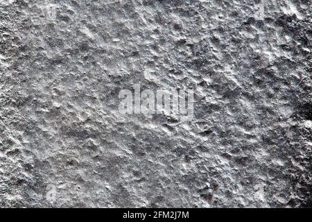 Closeup background of casting metal steel texture macro. Gray cast iron galvanized silver surface. Concept of lifeless desert surface of planet or Stock Photo