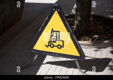 Forklift sign on city street. Yellow warning sign Stock Photo