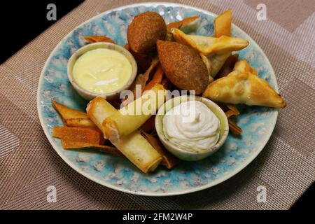 lebanese arabic food speciality deep fried hot mezze selection includes spinach fatayer, cheese rolls and lamd kebbe, meddle eastern food Stock Photo